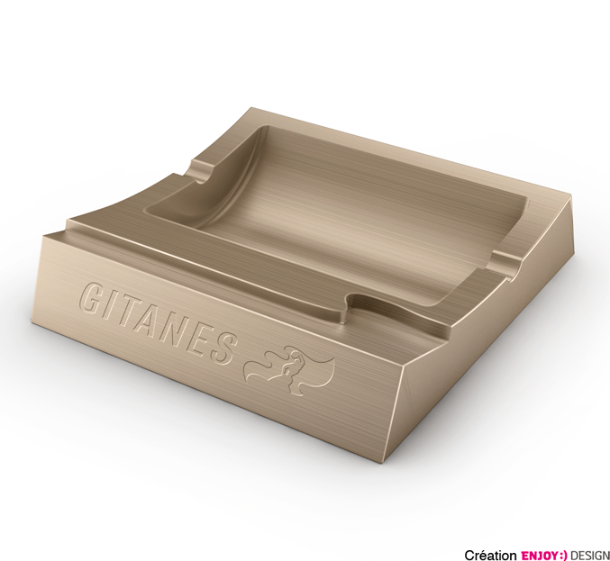 Exécution d‘objet de la marque GITANES BLONDES. Logotype en défonce sur matière acier pour un cendrier.